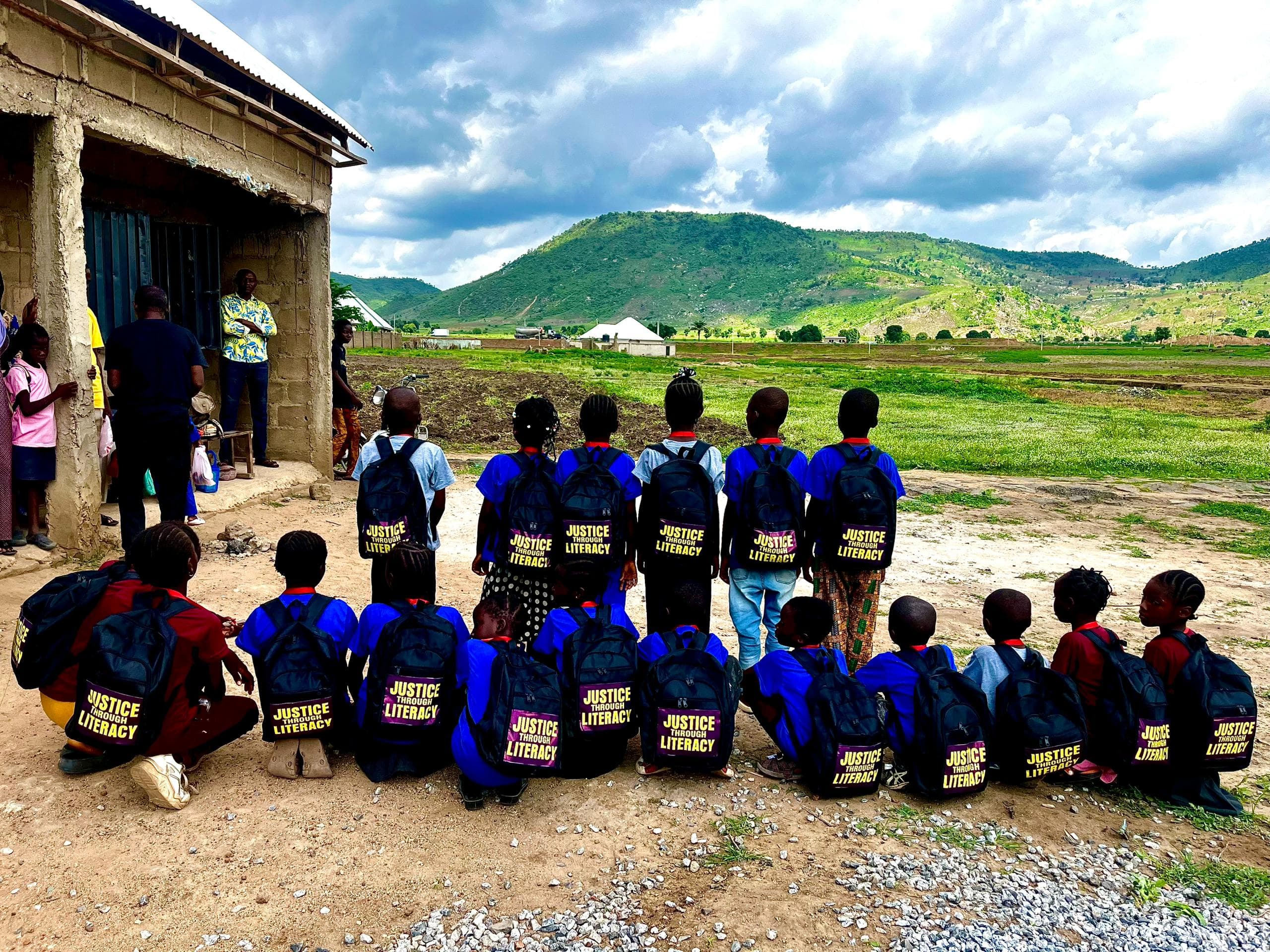 Children with Justice Through Literacy backpacks in Kwali